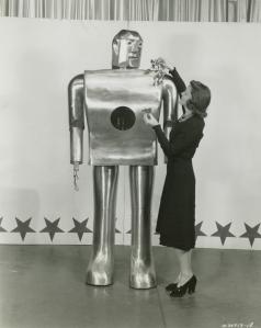 As musician Lois Kendall shows him red roses and green leaves, Elektro tells her the color of each. Source: NYPL
