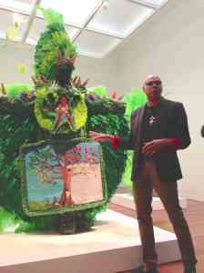Alonzo Wilson explains how the cycle of life and the seasons are reflected on the beaded apron of the "Big Chief: Tree of Life" costume.