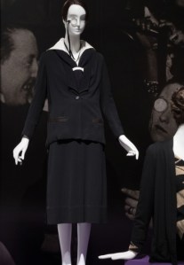 1924 short-hair, no-hips “boy” look with the signifying monocle. 