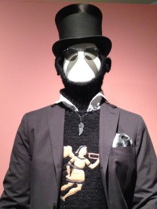 Closep-up of Michael Bastian’s sweater icon based upon an 1840s weathervane of the Archangel Gabriel. The look also features a hood with built-in earmuffs.