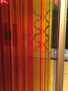 Other works seen through the1965-2009 plexiglass and steel piece by Carlos Cruz-Diez