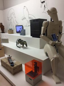 Installation view of The Universal Addressability of Dumb Things (Machine), with costume, Lego ship, copy of a 1959 Soviet space dog suit